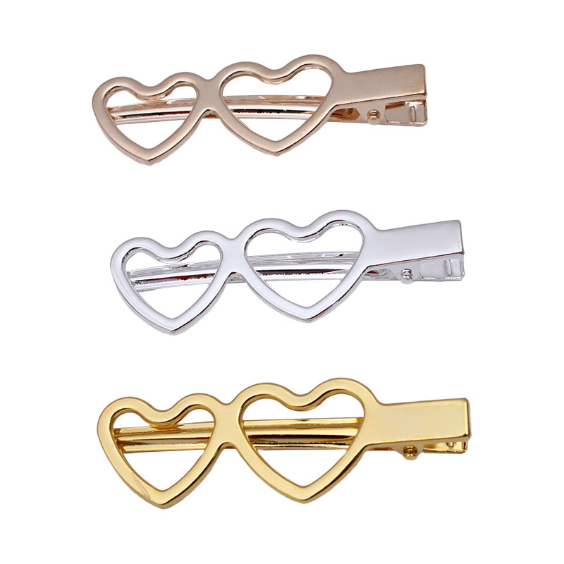 A Pair Of Heart-shaped Metal Hairpins