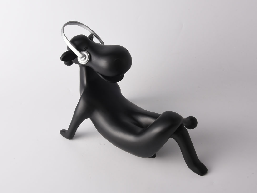 Декоративна скулптура от смола на крава със слушалки